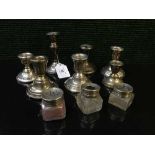 A collection of silver candlesticks,