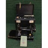 A mid 20th century cased miniature Singer sewing machine