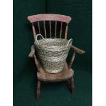 A pine armchair and a log basket