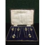 A set of six cased silver teaspoons and a pair of sugar tongs