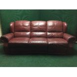 A burgandy leather three seater reclining settee