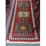 A fringed Persian rug with medallion design