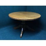 An oak pedestal dining table