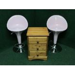 A pine three drawer bedside chest and a pair of pink and chrome bar stools