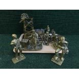 A tray of heavy brass ornaments - traction engine, mining figures,