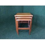 A nest of three mid 20th century teak tables