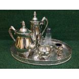 A silver plated gallery tray, three piece plated tea service, plated salts,