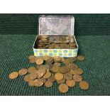 A tin of early twentieth century British pennies etc