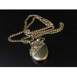 A gold locket on chain stamped 375, 5.
