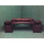 A mahogany stag dressing table fitted with three drawers together with a pair of bedside stands