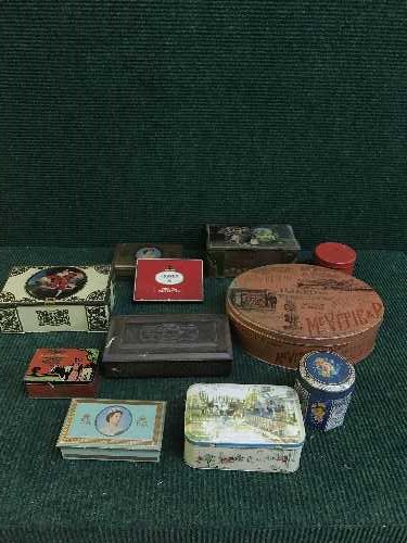 A basket of War Illustrated magazines and a box of vintage tins