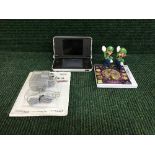 A Nintendo DS XL with charger and game