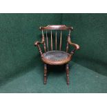 An early twentieth century mahogany ibex armchair together with an oak rush seated stool