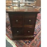 A four drawer mahogany cabinet