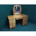 A pine knee hole dressing table fitted with eleven drawers