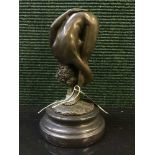 A bronze figure on stone base - Erotic study of standing lady bending down.