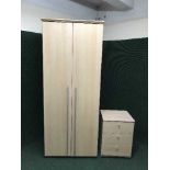 A beech effect double door wardrobe and three drawer chest