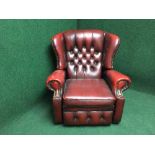 A red buttoned leather chesterfield reclining chair