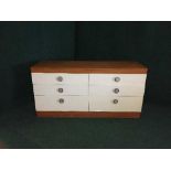 A late 20th century teak six drawer chest and a nest of three teak glass topped tables