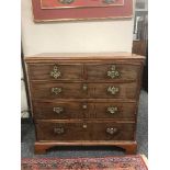 An antique mahogany chest of five drawers on bracket feet