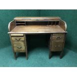 A late Victorian mahogany roll topped desk