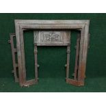 An antique cast iron fire insert