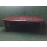 A Victorian mahogany wind out dining table