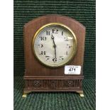 A mahogany mantel clock on brass bracket feet