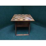 A storage table with chess board top containing chess pieces