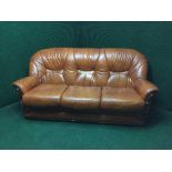 A tan leather three seater settee