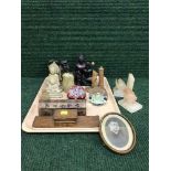 A tray of glass paperweights, three wooden monkeys,