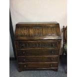 A carved oak bureau