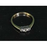 An 18ct gold three stone diamond ring