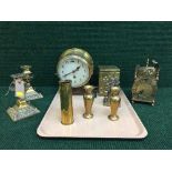 A circular brass Smiths clock, pair of candlesticks, tea caddy, carriage clock,