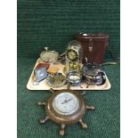 A tray of desk and travel clocks, clock under shade, ships wheel barometer, plated ware,