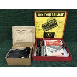 A boxed Trix twin railway set with manuals and a box of track and power supply