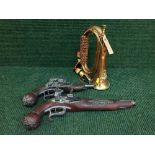 A brass and copper military bugle and two reproduction flint lock pistols