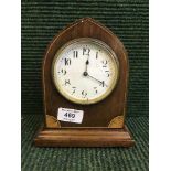 An inlaid mahogany arched topped mantel clock