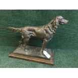 A bronze figure on a wooden base of a setter