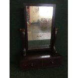 A Victorian mahogany toilet mirror fitted with two drawers