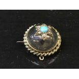 A yellow metal and rock crystal brooch set with diamonds and turquoise