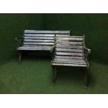 A wrought iron and wooden garden bench with matching chair