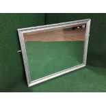 A silvered framed over mantel mirror