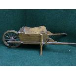 A mid twentieth century small pine wheel barrow