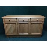 A contemporary oak effect triple door sideboard