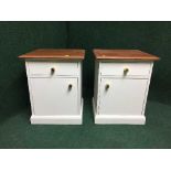 A pair of painted teak topped bedside cabinets