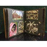 A postcard album containing assorted cards monochrome images,