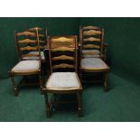 An oak gateleg table together with a set of four ladder backed chairs