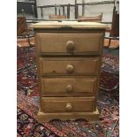 A narrow pine four drawer chest