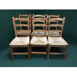 A set of six pine rush seated ladder backed chairs